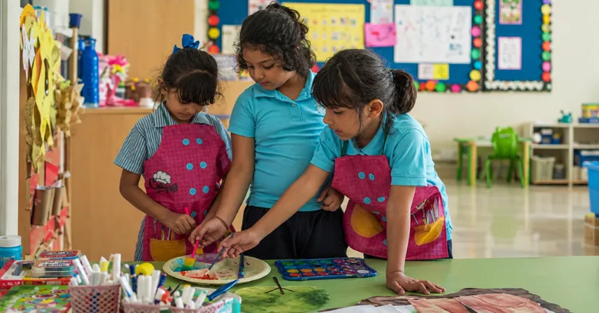 Three girls are doing a class activity