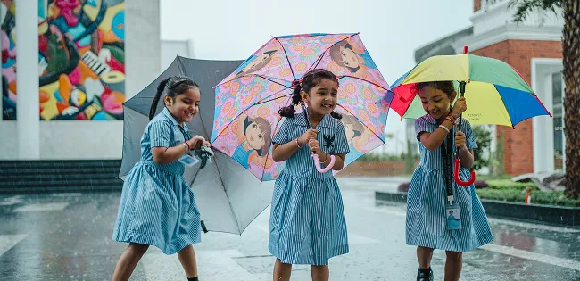 Girls walking with umbrellas in the rain