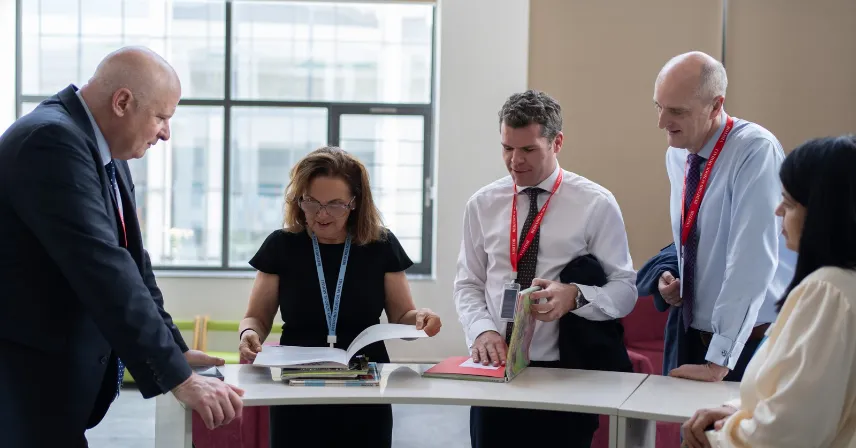 Bedford School (UK) and Bedford School Mohali leaders reviewing educational documents during a school evaluation.